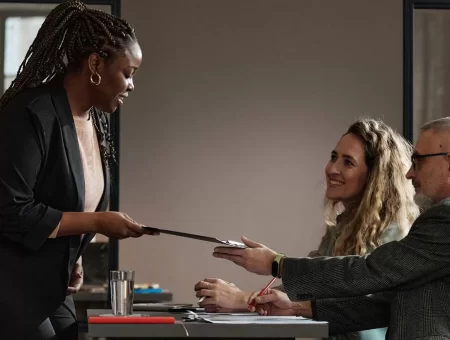 woman-giving-her-resume-to-interviewer-TCTJC8J.jpg